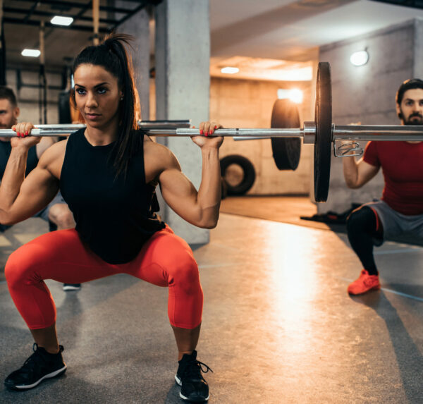 Get ready to get sweaty Shot of two young men and a woman lifting weights at the gym