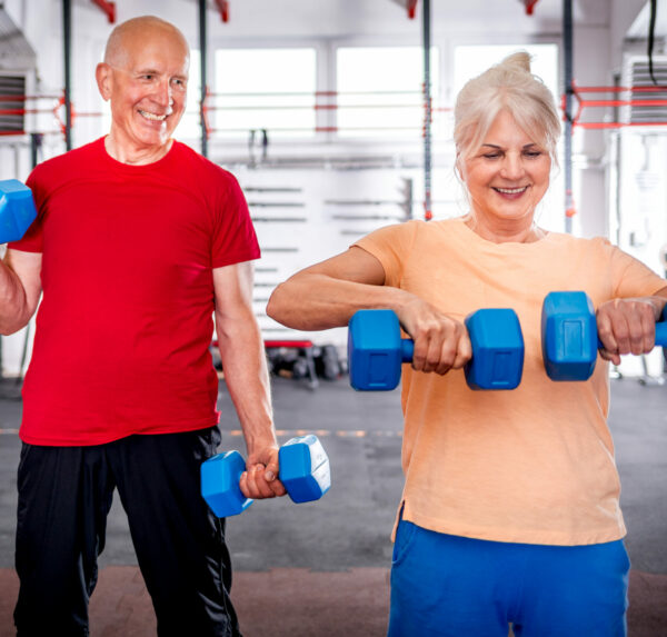 Senior people with dumbbells doing exercises at the gym Senior people with dumbbells doing exercises at the gym